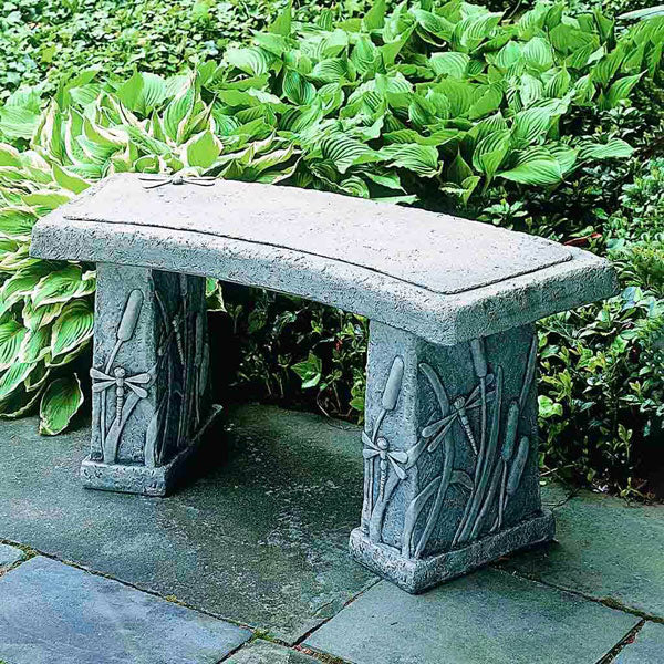 Dragonfly Curved Bench on concrete in the backyard.