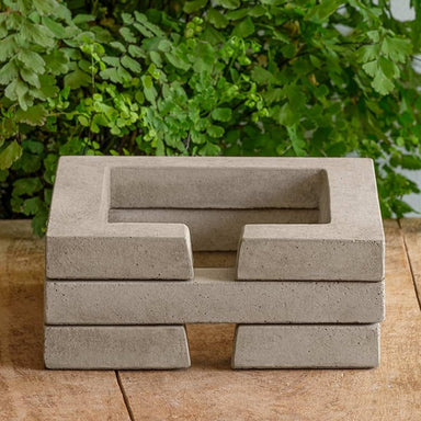 Guard Riser Square on table against green leaves.