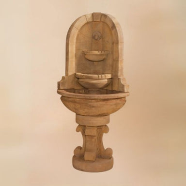 Montefalco Corner Fountain with concrete water spout against brown background.