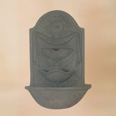 Navona Wall Fountain against brown background.