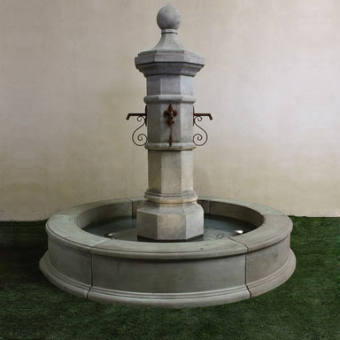 Octavia Column Only Plumbed for pond on grass against white wall.