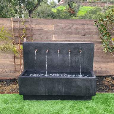 Penta Wall Fountain in iron color in action.