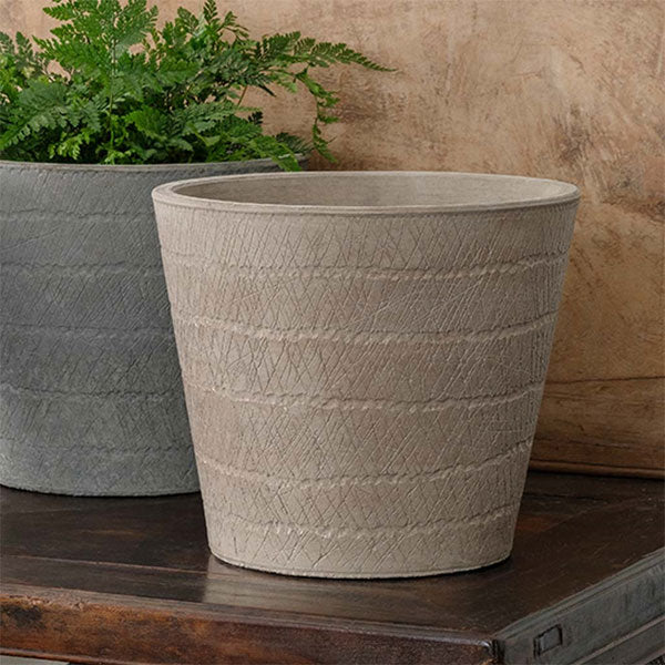 Samba Planter - Brown on table beside planter filled with plants