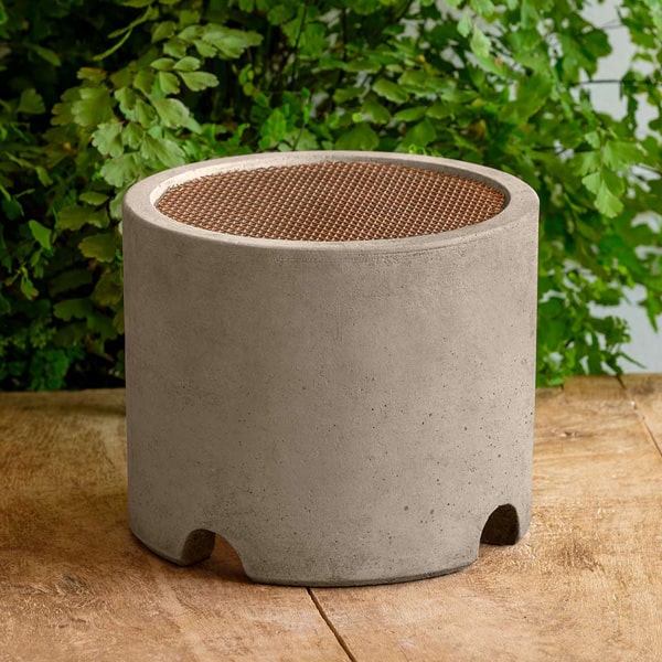 Splash Guard Round Wide on table against green leaves