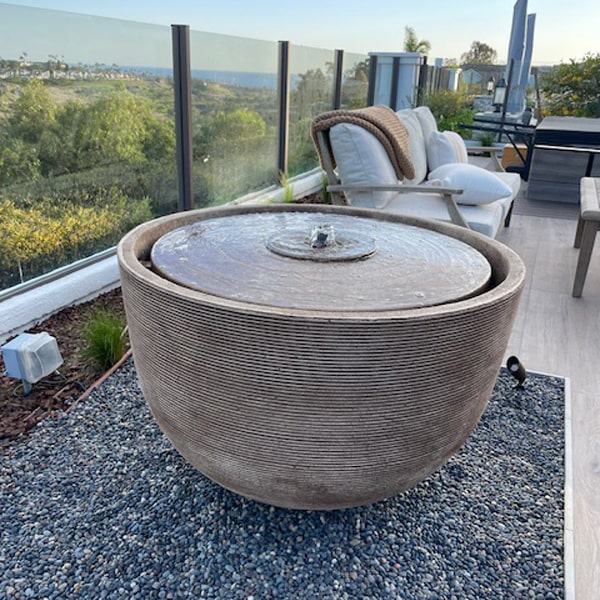 Alta Girona Fountain in brownstone color on deck overlooking pacific ocean.