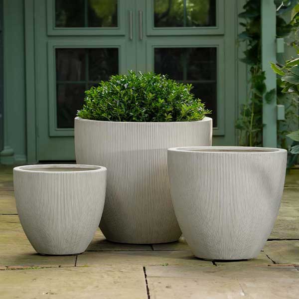 Airy Planter, Small - Alabaster Lite on concrete filled with plants