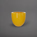 Alzira Round Fiberglass Planter in gloss saffron against gray background.