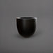 Alzira Round Fiberglass Planter in matte black against gray background.
