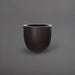 Alzira Round Fiberglass Planter in matte charcoal against gray background.