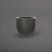 Alzira Round Fiberglass Planter in matte gunmetal against gray background.