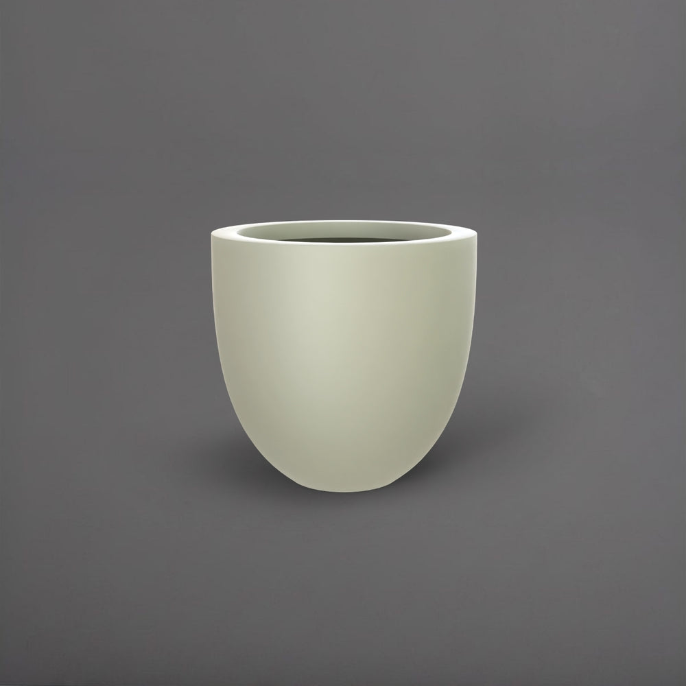 Alzira Round Fiberglass Planter in satin beige against gray background.