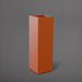 Amesbury Tall Corner Planter in matte terra cotta against gray background.