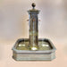 Anduze Colone Fountain against brown background.