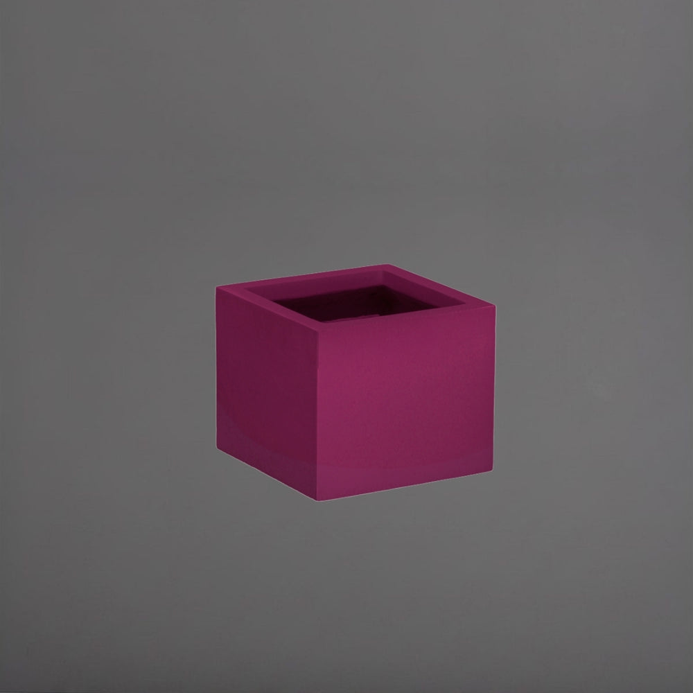 Antwerp Corner Fiberglass Planter in gloss eggplant against gray background.