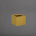 Antwerp Corner Fiberglass Planter in gloss metallic gold against gray background.