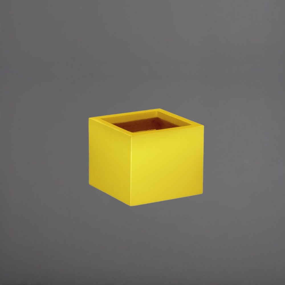 Antwerp Corner Fiberglass Planter in gloss saffron against gray background.