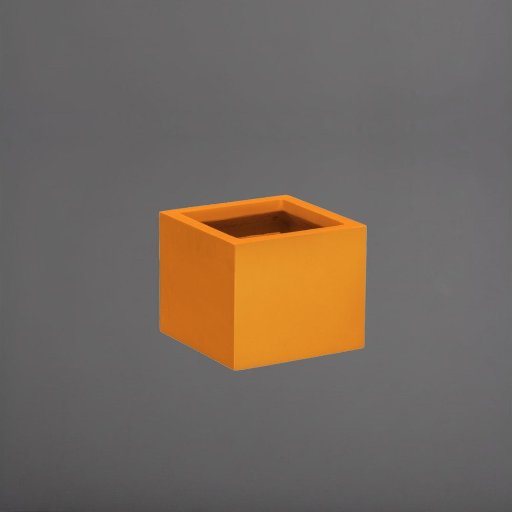 Antwerp Corner Fiberglass Planter in gloss tangerine against gray background.