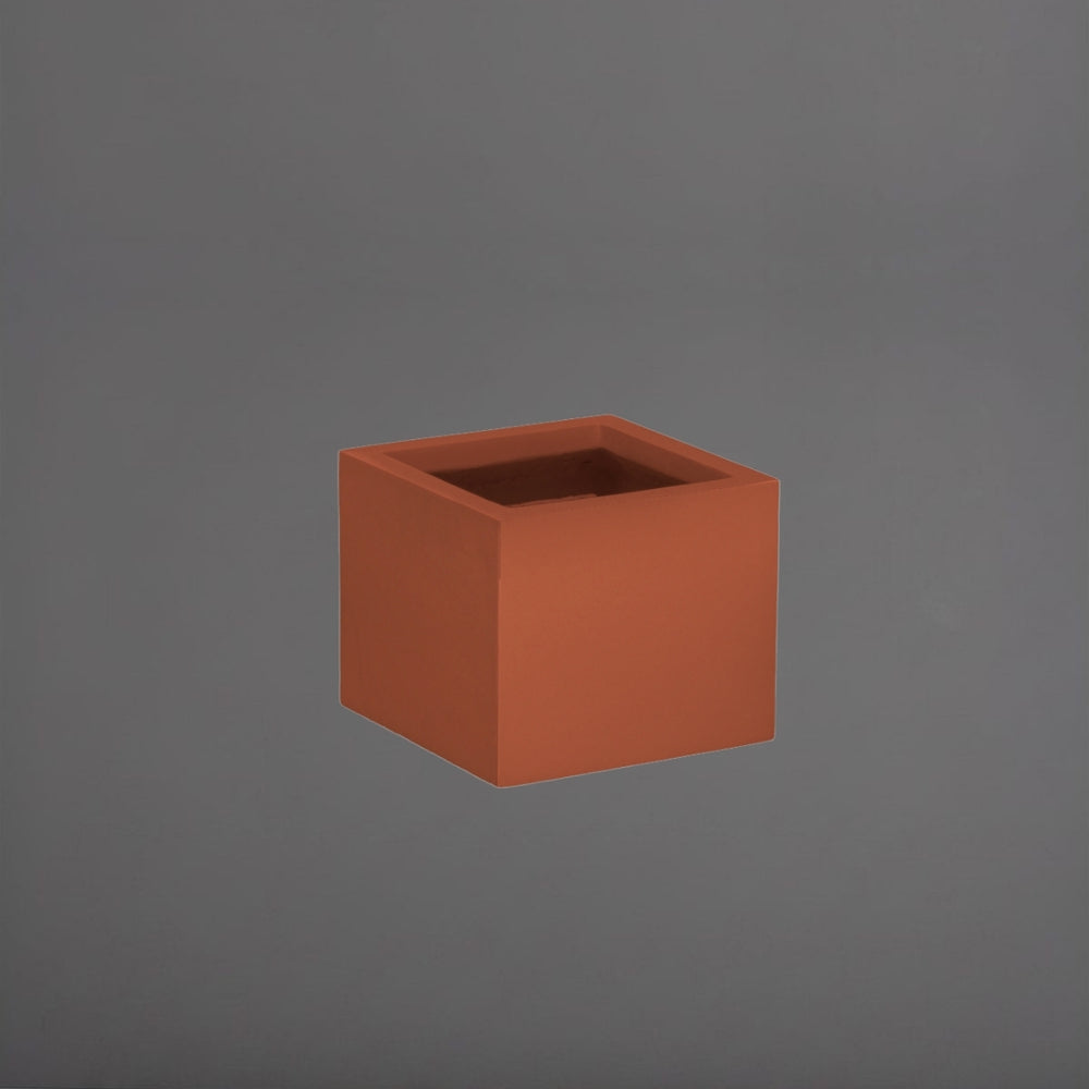 Antwerp Corner Fiberglass Planter in matte terra cotta against gray background.