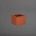 Antwerp Corner Fiberglass Planter in matte terra cotta against gray background.