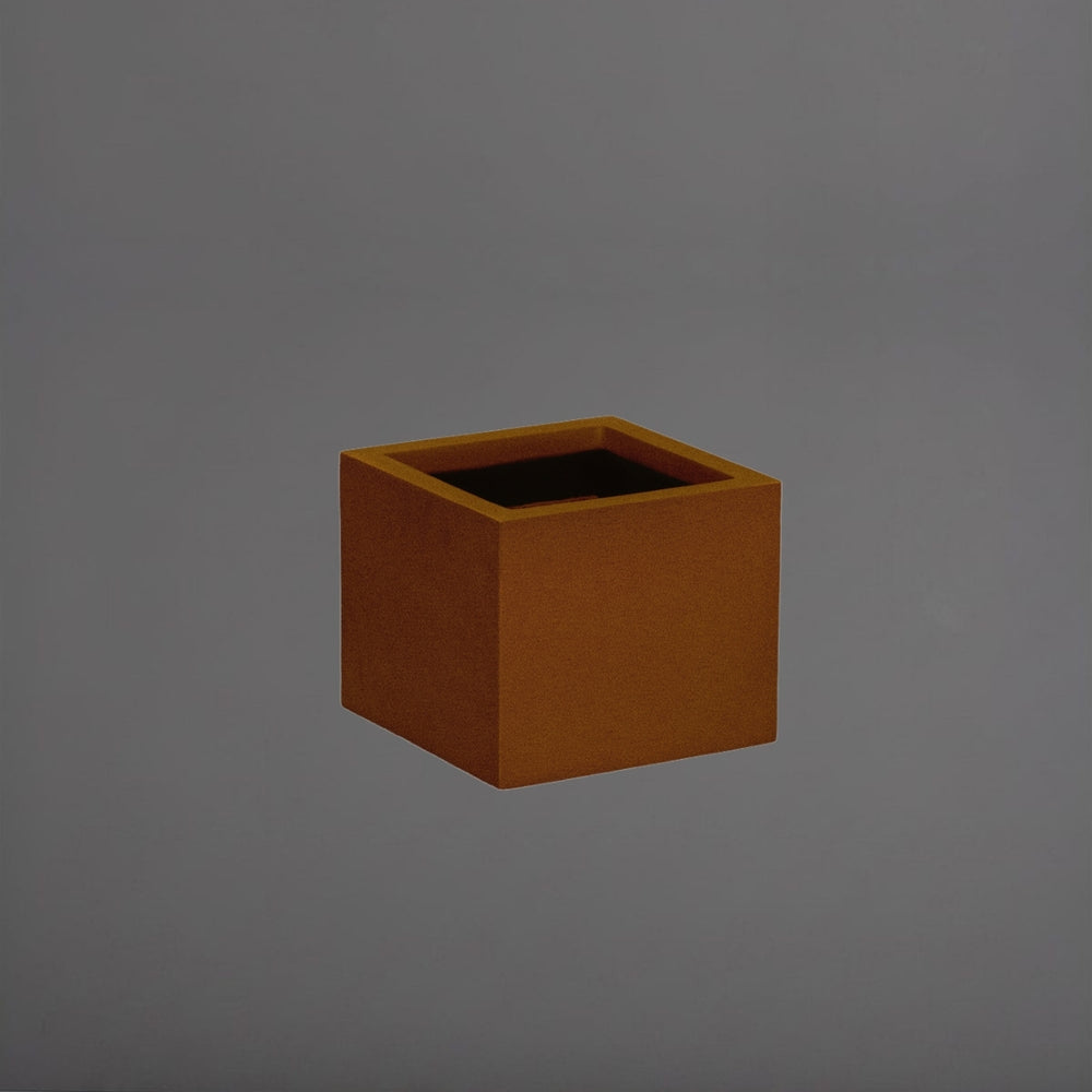 Antwerp Corner Fiberglass Planter in metallic bronze against gray background.
