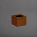 Antwerp Corner Fiberglass Planter in metallic bronze against gray background.