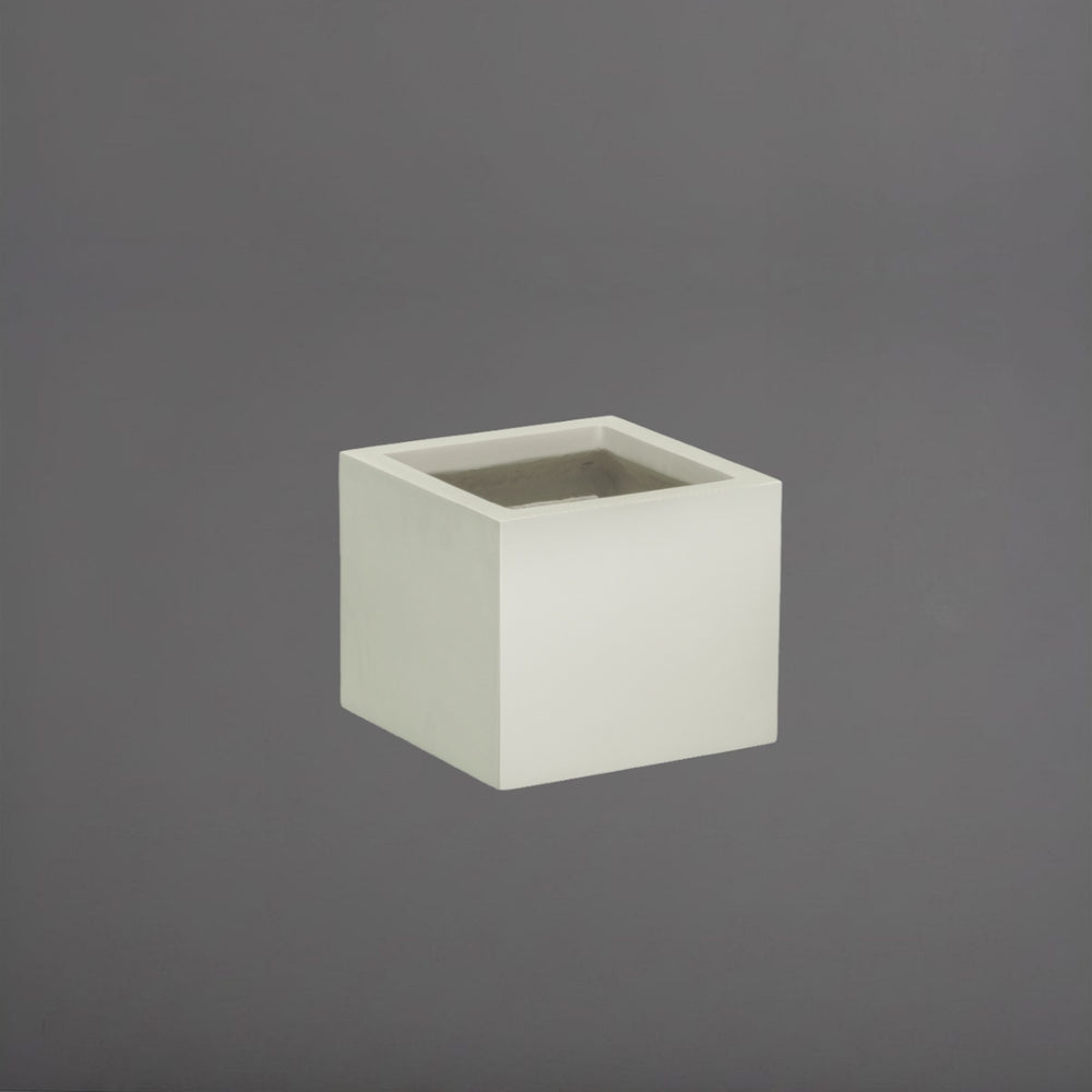 Antwerp Corner Fiberglass Planter in satin beige against gray background.