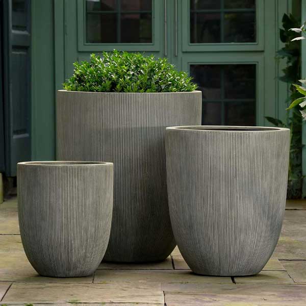 Argo Planter, Large - Ash Grey Lite on concrete filled with plants