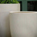 rago Planter, Small - Alabaster Lite on concrete upclose