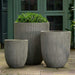 Arago Planter, Small - Ash Grey Lite on concrete filled with plants