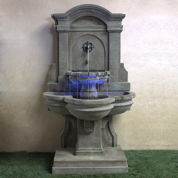 Arbois Wall Fountain on grass in the backyard.