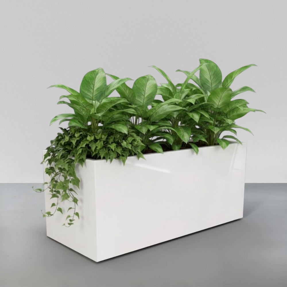 Badalona Rectangle Fiberglass  Planter filled with plants against gray backdrop