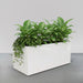 Badalona Rectangle Fiberglass  Planter filled with plants against gray backdrop