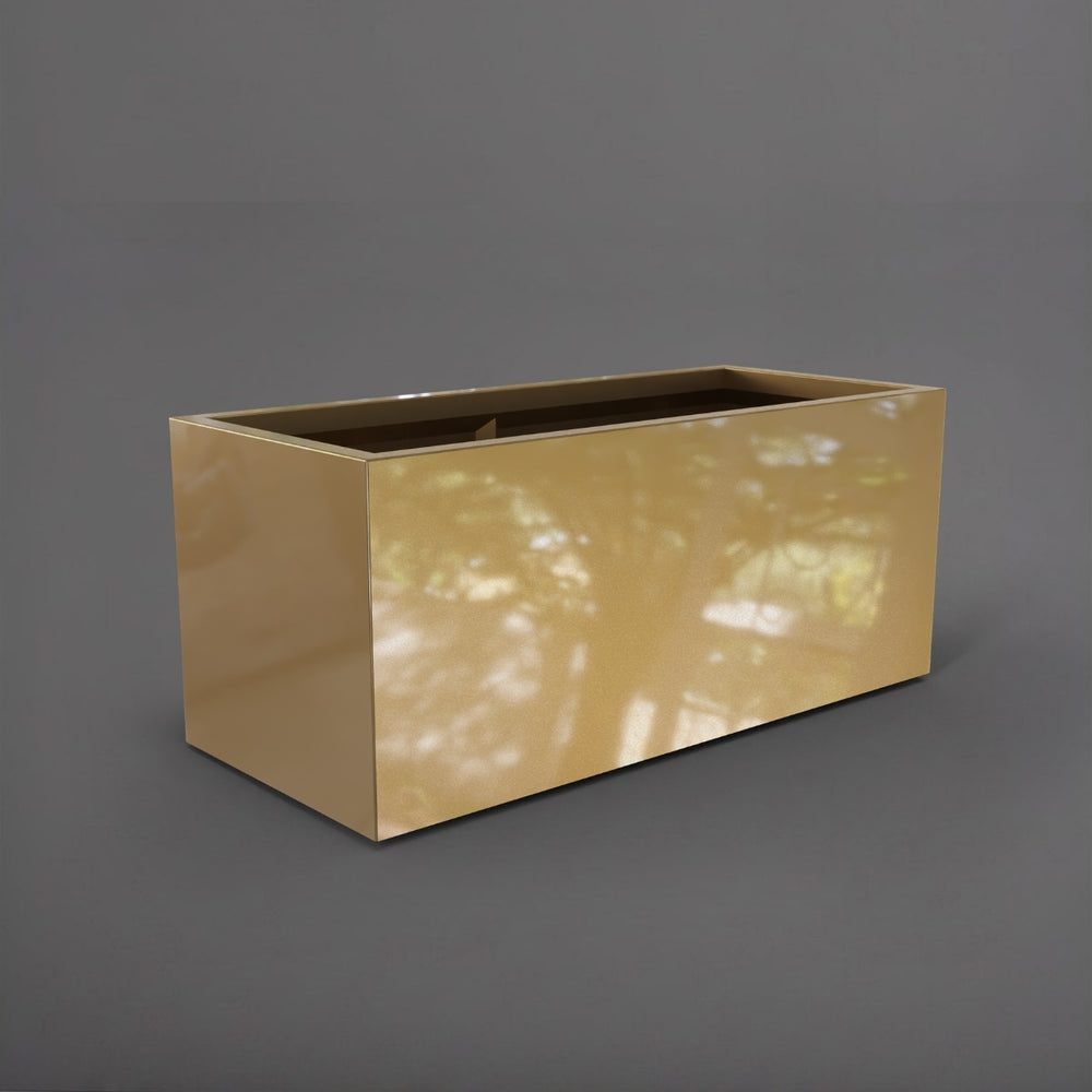 Badalona Rectangle Fiberglass Planter in gloss metalllic gold against gray background.