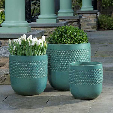 Banded Coin Pot - Glacier Green - S/3 on concrete filled with plants