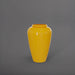 Bara Jar Tall Tapered Fiberglass Planter in gloss saffron against gray background.