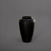 Bara Jar Tall Tapered Fiberglass Planter in matte black against gray background.