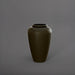 Bara Jar Tall Tapered Fiberglass Planter in matte bronze against gray background.