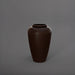 Bara Jar Tall Tapered Fiberglass Planter in matte dark brown against gray background.