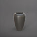Bara Jar Tall Tapered Fiberglass Planter in matte gunmetal against gray background.