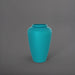 Bara Jar Tall Tapered Fiberglass Planter in satin seafoam green against gray background.