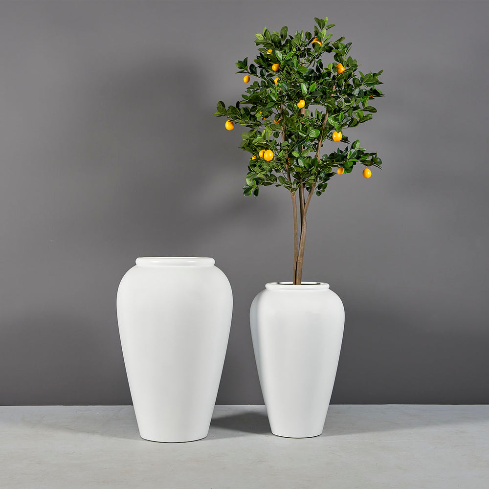 Bara Jar Tall Tapered Fiberglass Planter shown with different sizes filled with plants.