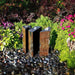 Basalt Fountain Kit 36 Triple Split Polished 3 piece on black pebbles in the backyard