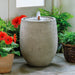 Bebel Fountain on concrete beside orange flowers