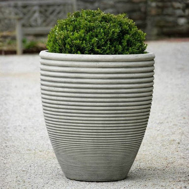 Bibendum Planter, Large on gravel filled with plants.