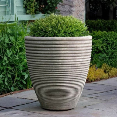Bibendum Planter, Small on gravel filled with plants.