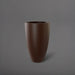 Brannan Tapered Round Fiberglass Planter in matte dark brown against gray background.