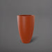 Brannan Tapered Round Fiberglass Planter in matte terra cotta against gray background.