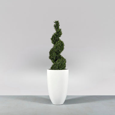Brannan Tapered Round Fiberglass Planter on concrete filled with plants.