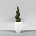 Brannan Tapered Round Fiberglass Planter on concrete filled with plants.