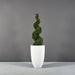 Brannan Tapered Round Fiberglass Planter on concrete filled with plants.